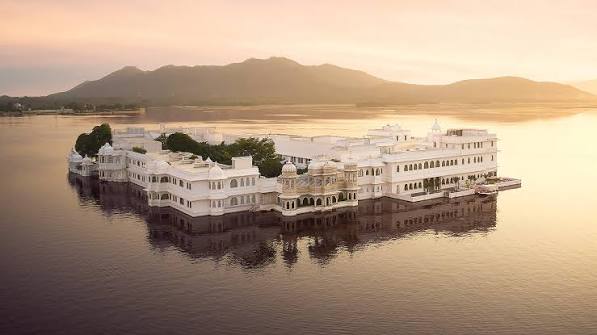 Aerial view of Udaipur City Palace at sunset over Lake Pichola